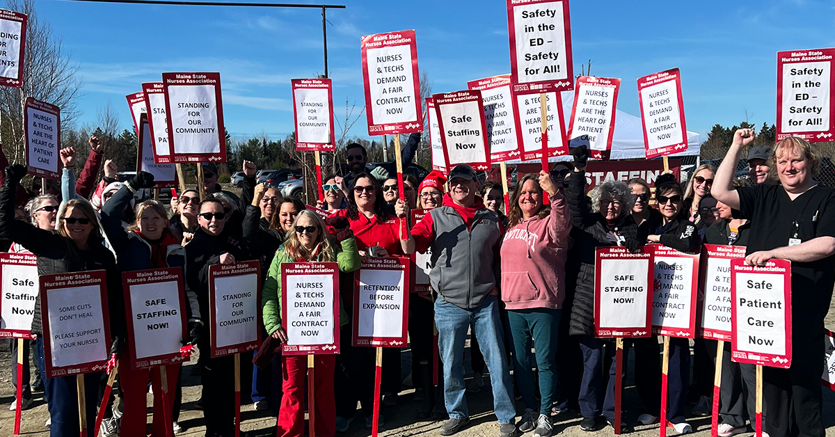 Large group of Machias nurses and techs on the strike line with lots of picket signs about staffing and retention