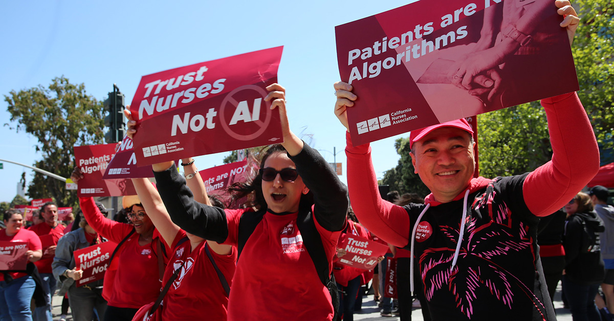 Nurses marching holding signs "Trust Nurses, Not AI" and "Patients Are Not Algorithms"