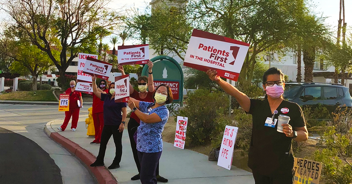 Nurses outside holding signs "Patients First in the Hospital"
