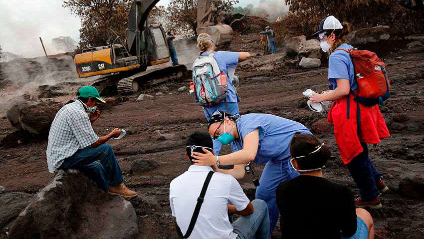 Nurses treat the eyes of people who continue to search for the remains of family members near Fuego volcano in Escuintla, Guatemala, in 2018