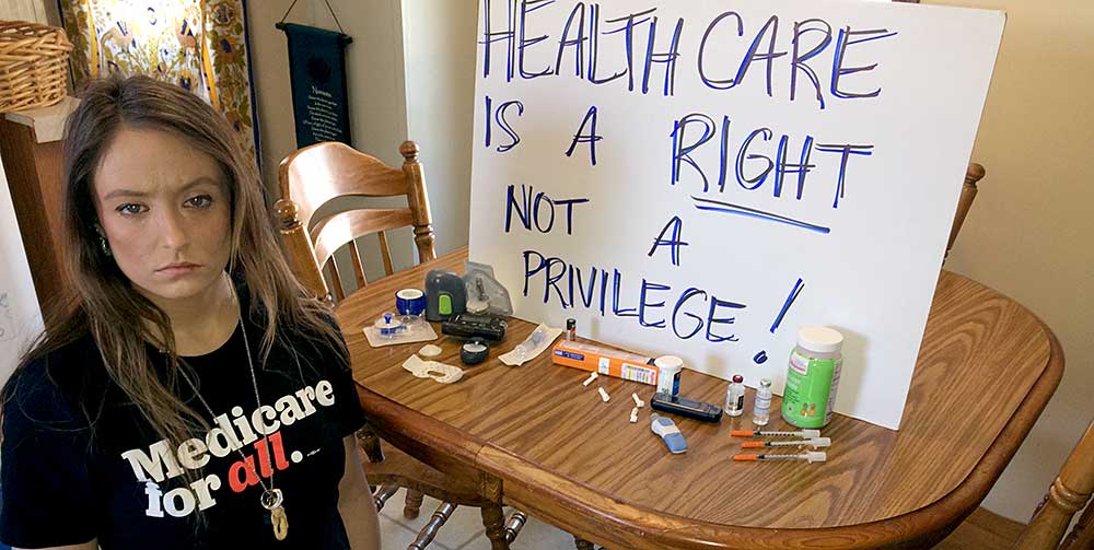 Briana Moss, 30, with the supplies she needs to survive type 1 diabetes.