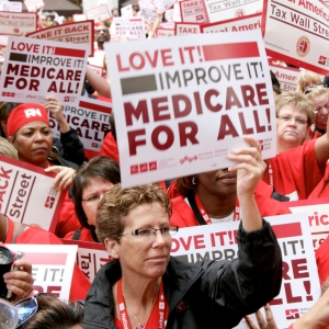 Nurse holding medicare for all sign