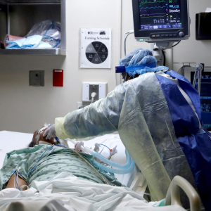 Nurse tends to patient in hospital bed