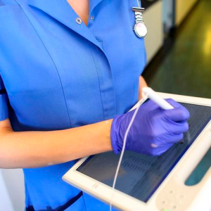 A nurse using a wireless electronic tablet 