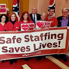 Nurses holding banner "Safe Staffing Saves Lives!"