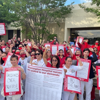 WHHS nurses gathered holding signs in support of safe staffing.