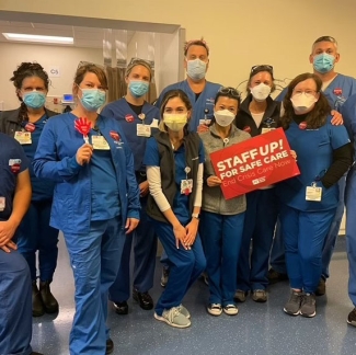 UCSF nurses hold signs in support of safe staffing.