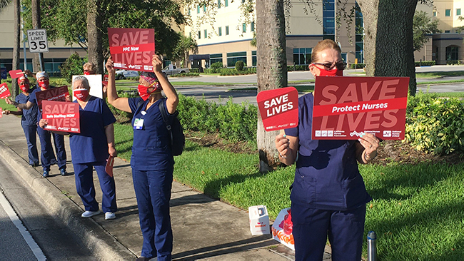 Nurses hold signs "Protect Nurses"