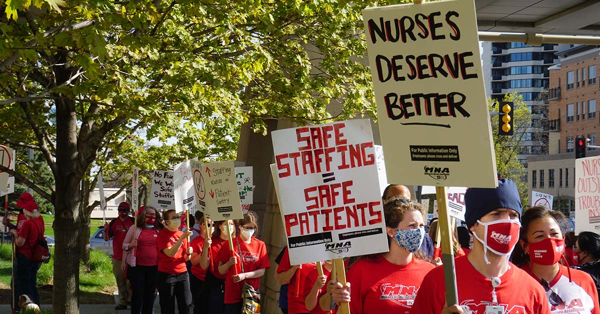 MNA mebers marching outside holding signs calling for safe staffing