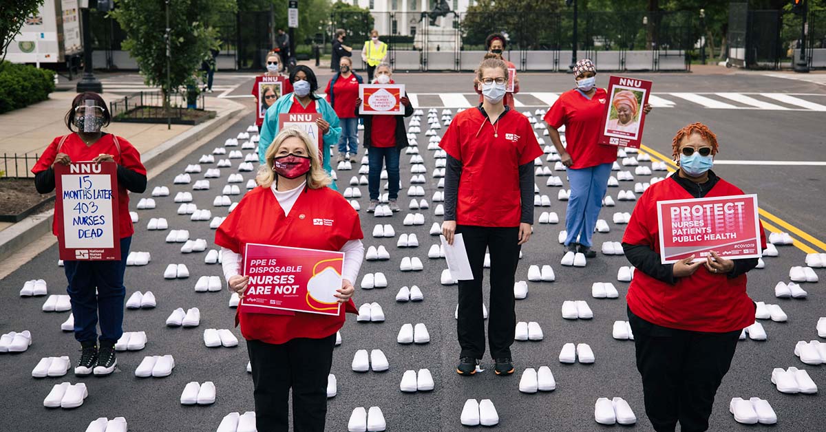 Nurses outside The White House holding signs calling for nurse, patient, and public safety