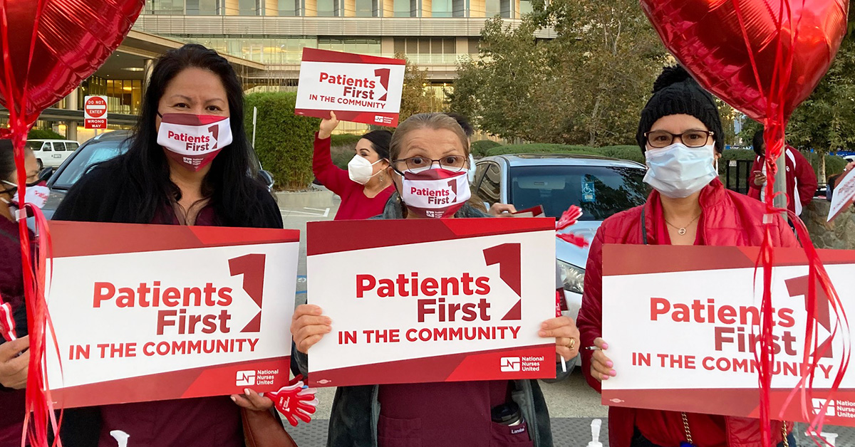 Three nurses outside hold signs "Patients First"