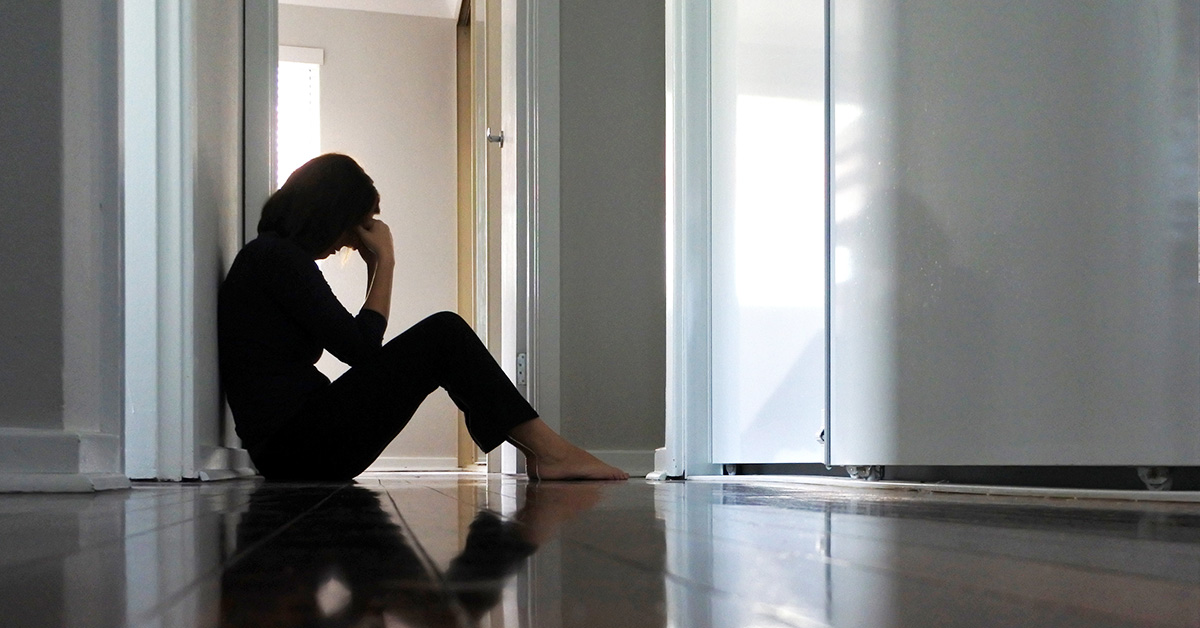 Distressed woman on floor of hallway