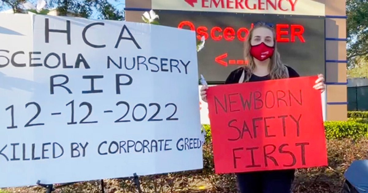 Nurse holds sign "Newborn Safety First"