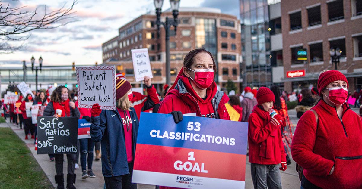 Line of Sparrow nurses outside holding signs for patient safety