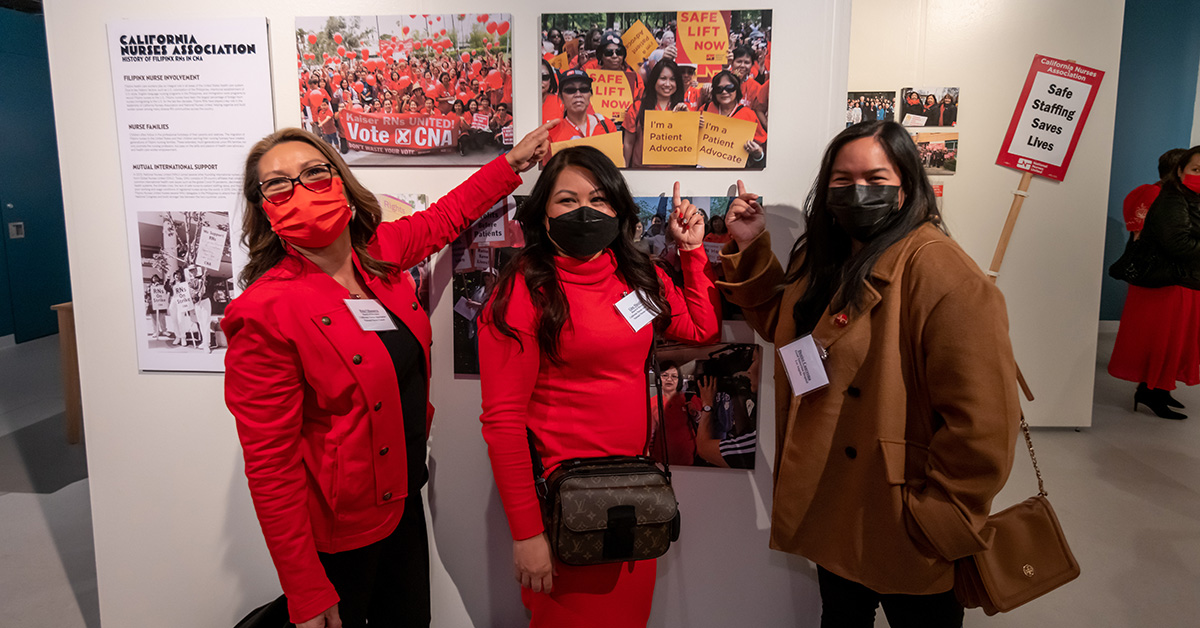 Nurses standing in front of art exhibit