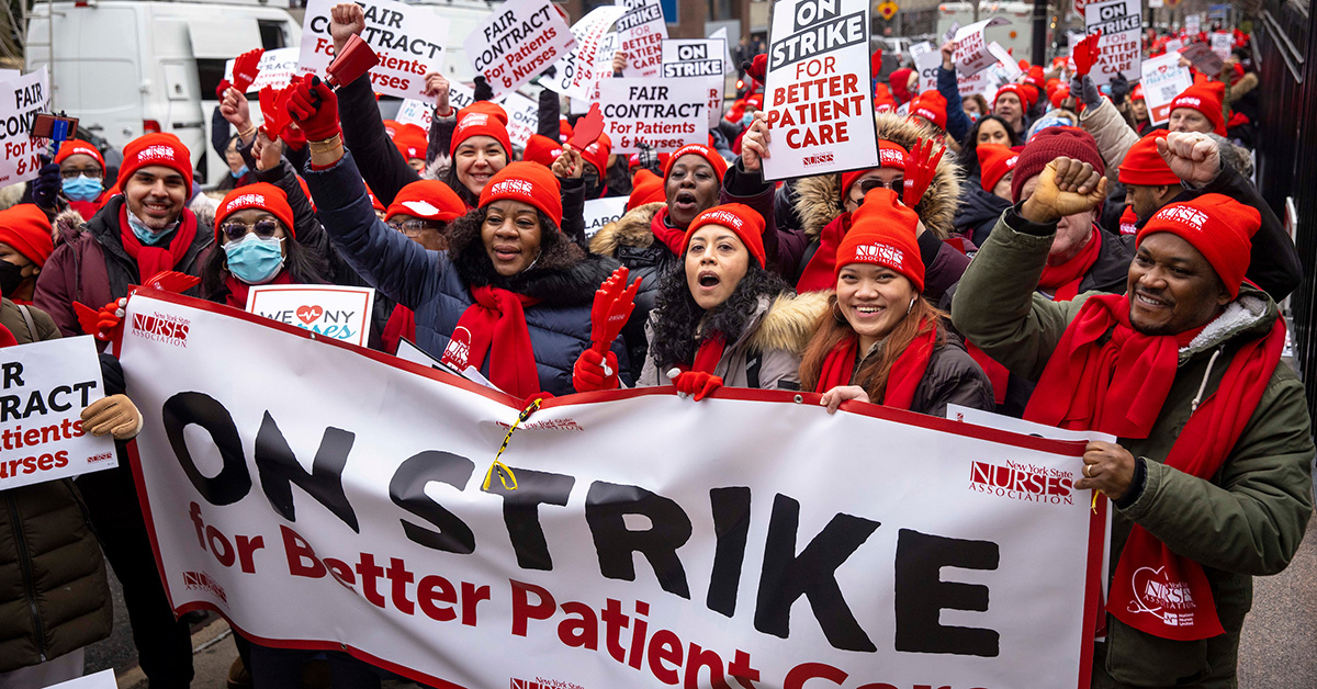 Large group of nurses marching with banner "On Strike for Patient Safety"