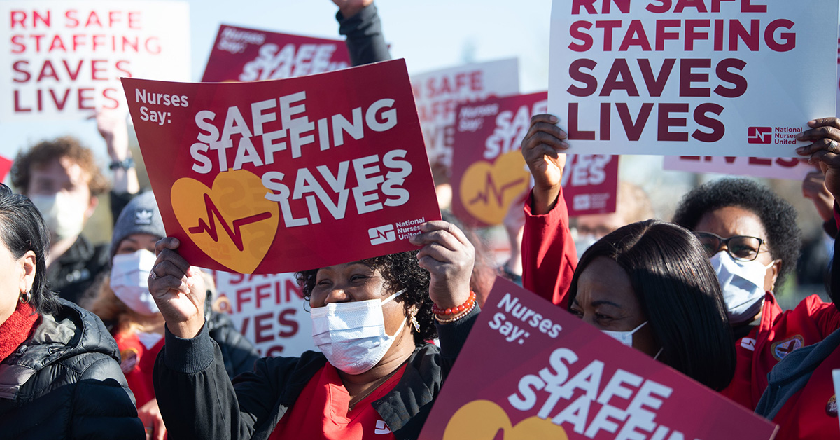 Nurses holding signs "Safe Staffing Saves Lives"