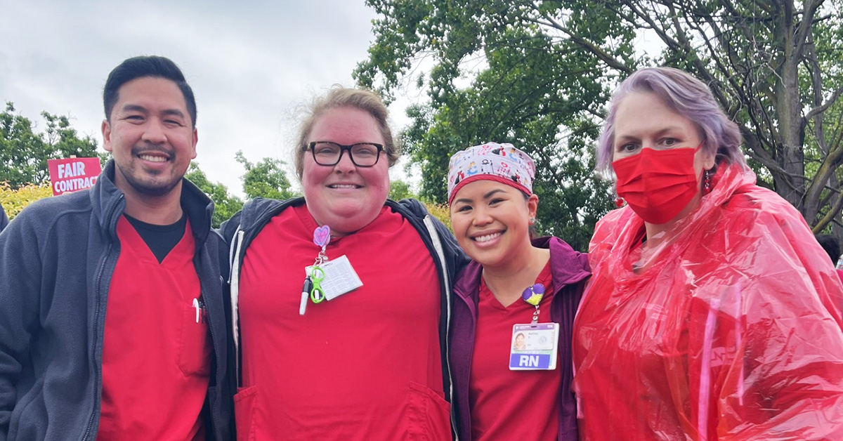 Four nurses side by side outside smiling