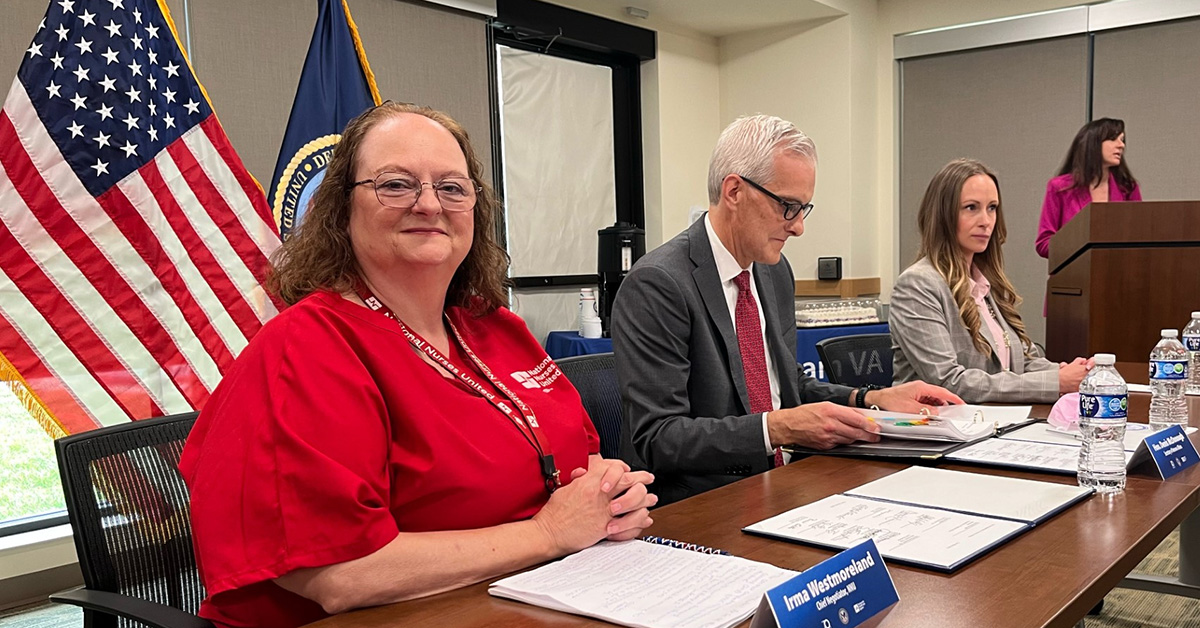 VA nurse sits at bargaining table smiling