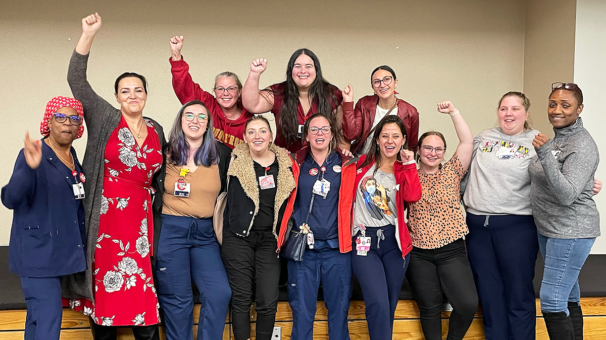 Joyous Saint Agnes nurses with fists raised