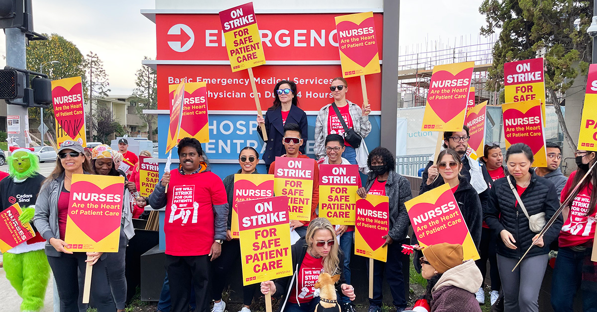 Large group of nurses outside Cedars-Sinai Marina del Rey Hospital hold signs "On strike for safe patient care"