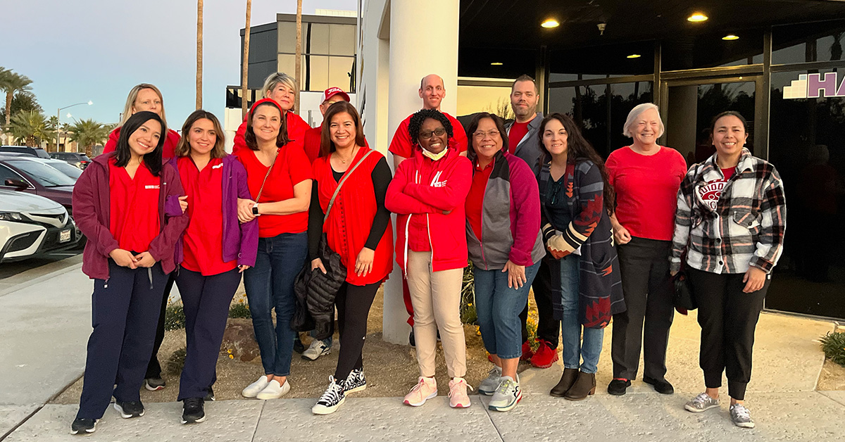 Large group of nurses outside Desert Regional Medical Center smiling