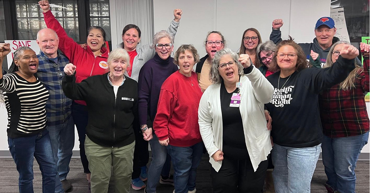 Group of nurses smiling with raised fists