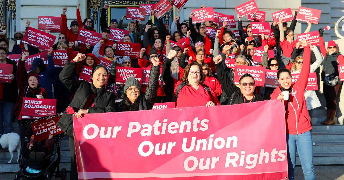 Large group of nurses holding signs and banner "Our Patients, Our Union, Our Rights"