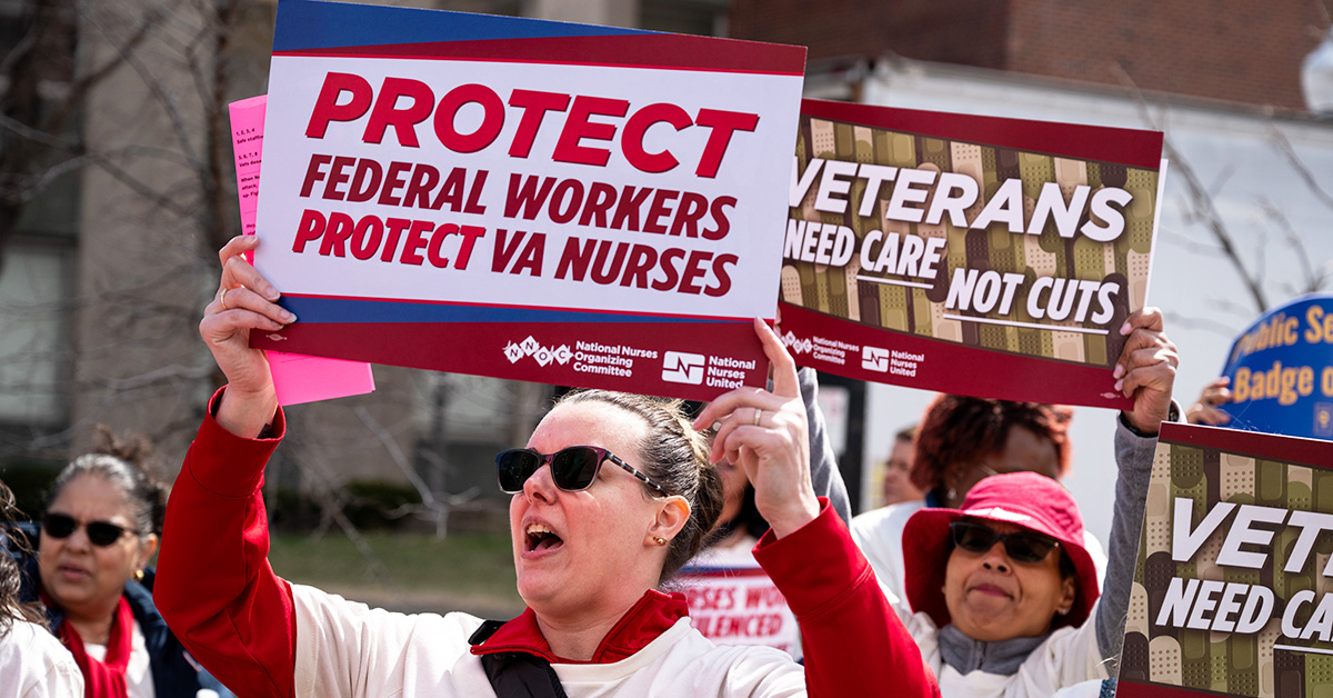 Nurses at rally holding signs "Protect Federal Workers, Protect VA Nurses"