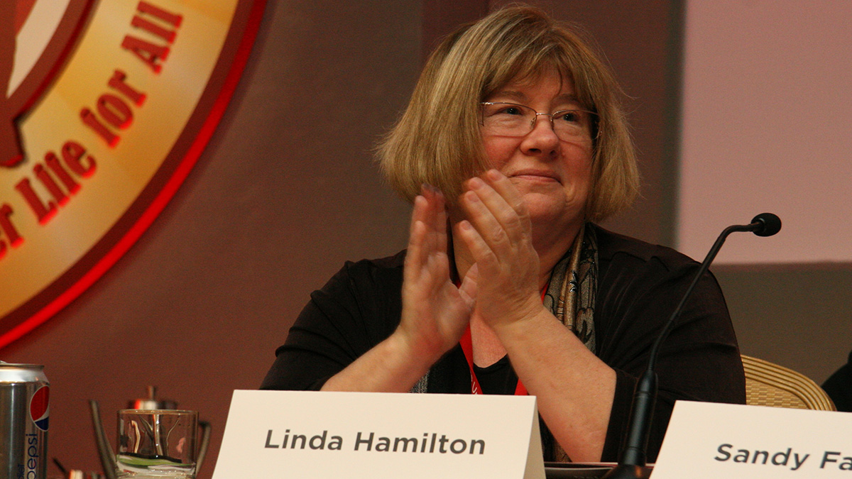 Linda Hamilton sitting at panel table