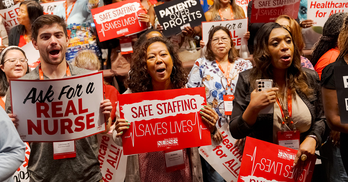 Nurses holding signs "Ask for a real nurse" and "Saf Staffing Saves Lives"