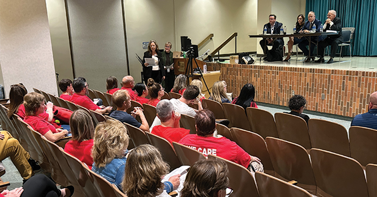 Panel being held inside theater room with nurses in front rows