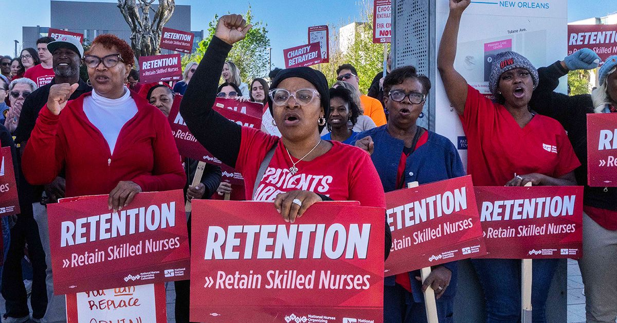Nurses on picket line with raised fists and holding signs "Retention: Retain Skilled Nurses"