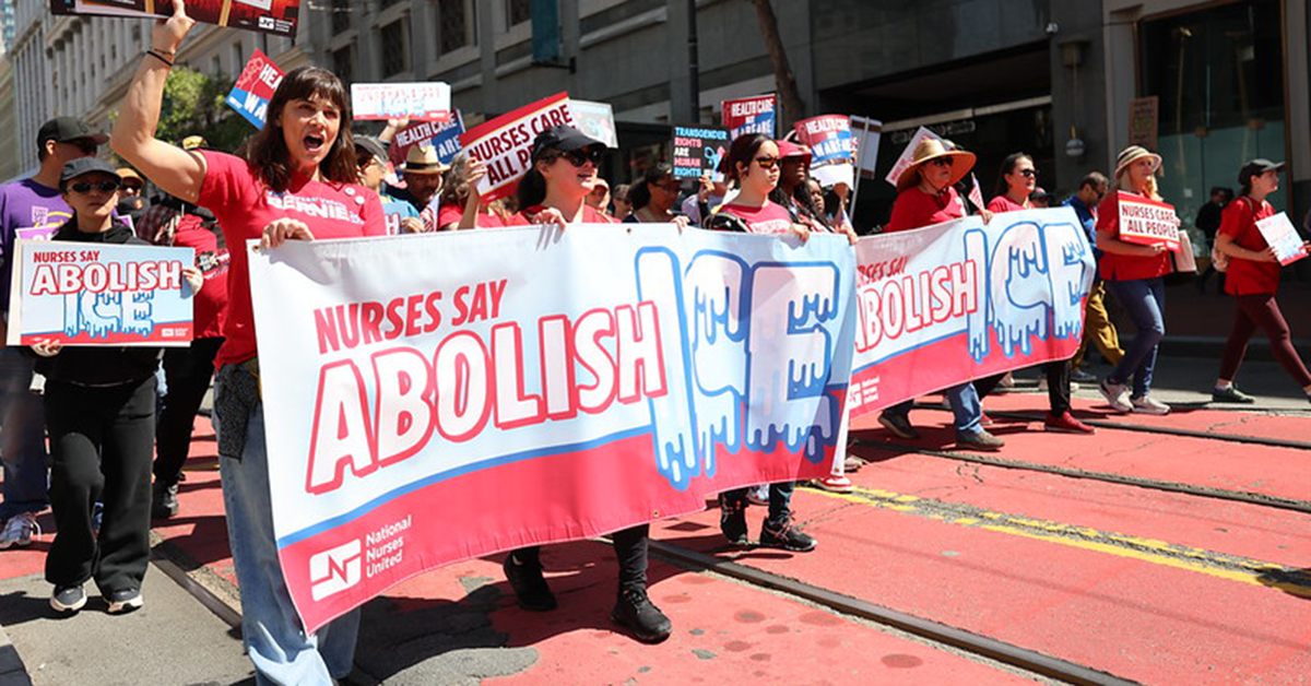 Nurse hold "Nurses say abolish ICE!" banner at rally