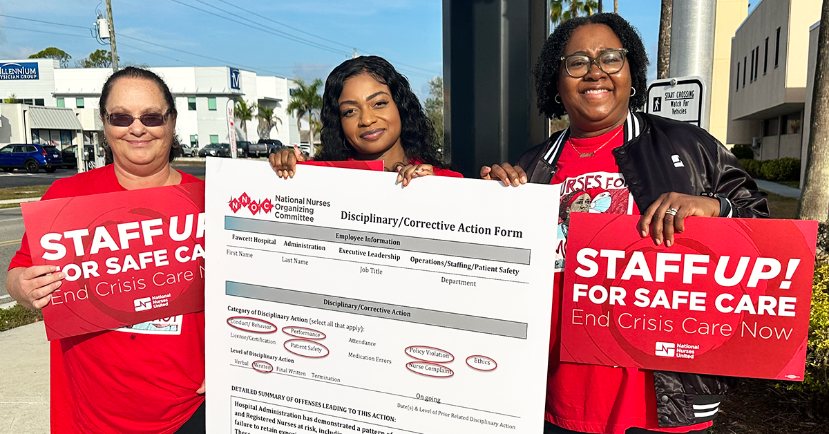 Three nurses holding signs "Staff up for safe care: End crisis care now" and a huge disciplinary/corrective action form
