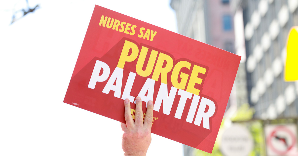 Hand holding sign '"Nurses Say Purge Palantir"