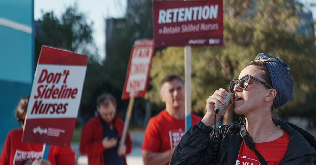 UMC nurses on strike with picket sign that reads "Don't sideline nurses."
