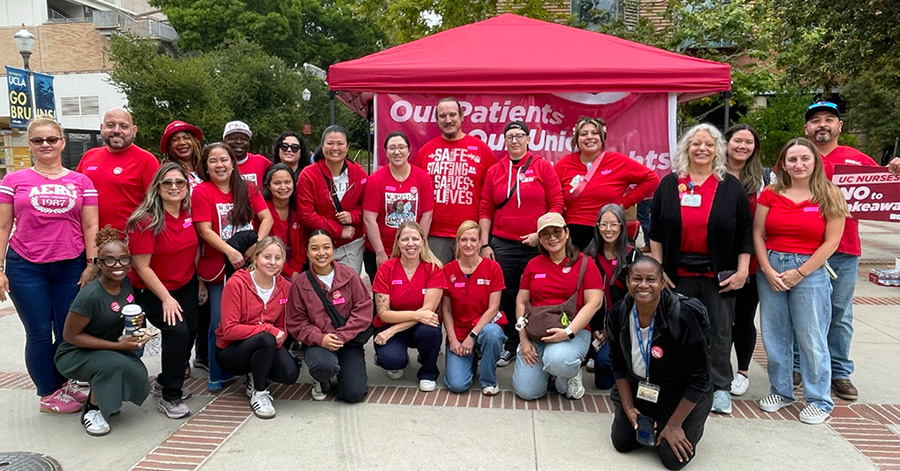 Large group of nurses posing, smiling, wearing red.