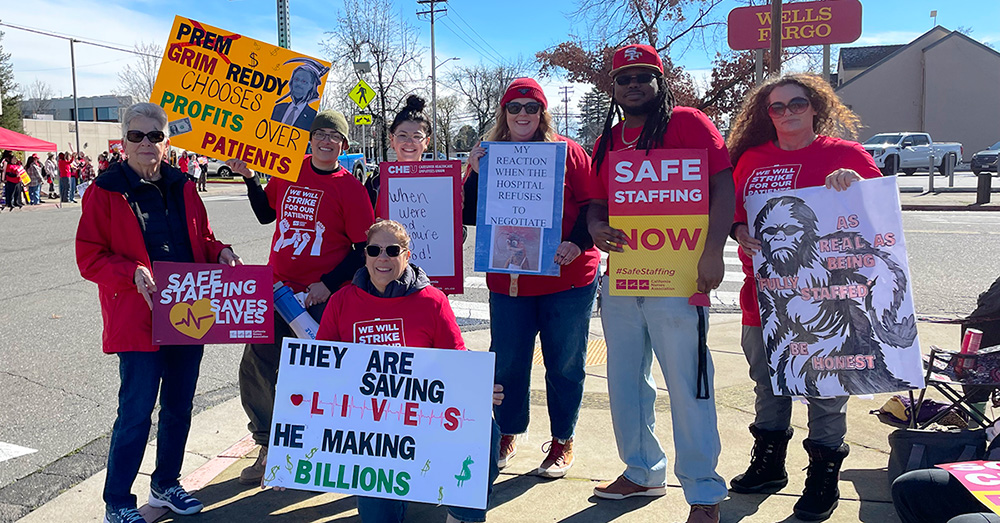 Nurses on strike line holding signs