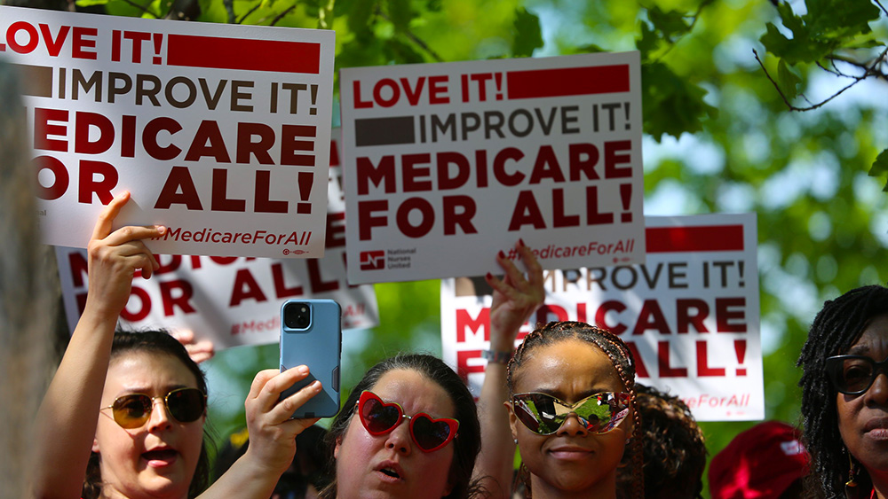 Nurses holdings signs "Love It! Improve It! Medicare for All!"