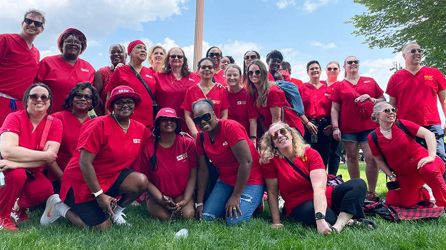 Large group of VA nurses smiling, wearing red