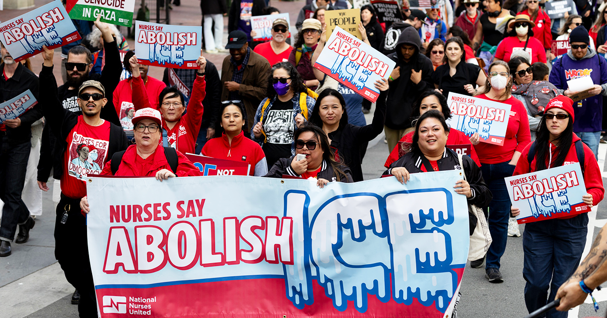 Nurses marching with Abolish ICE banners and signs.