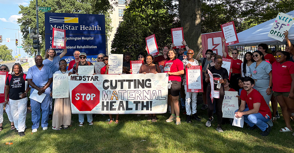 Large group of nurses and community members outside MedStar hospital holding banner "MedStar: Stop Cutting Maternal Health"