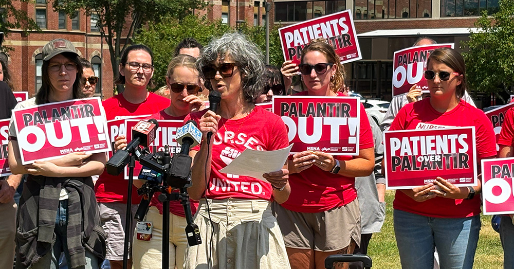 Nurses holding press conference in front of hospital, holding signs "Palantir Out!"