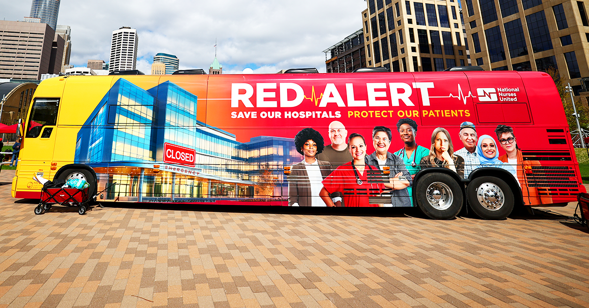 Picture of Red Alert tour bus against city backdrop