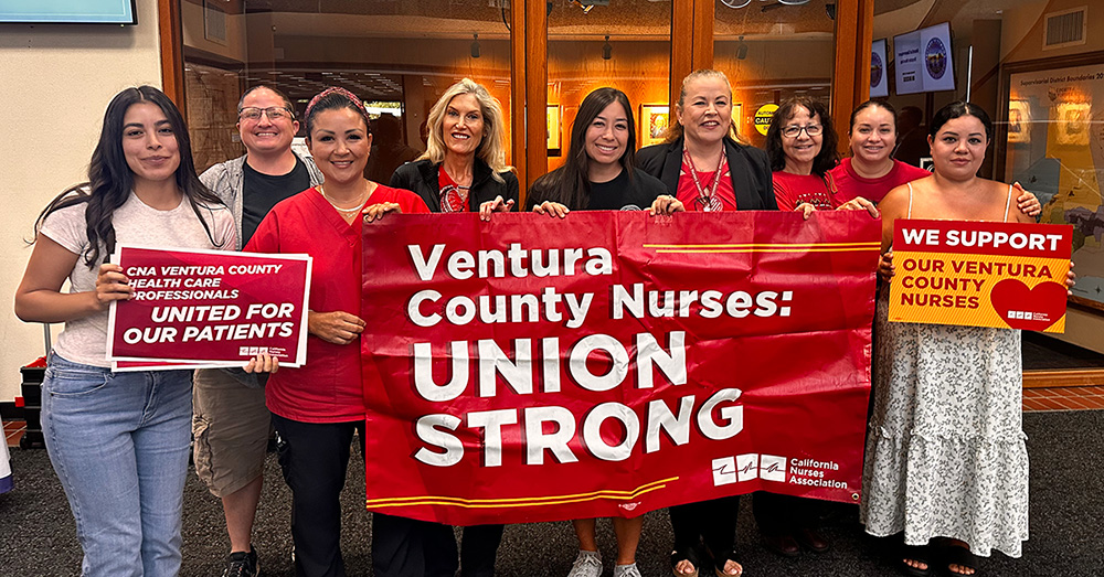 Group of nurses inside, smiling, holding banner "Ventura County Nurses: Union Strong"