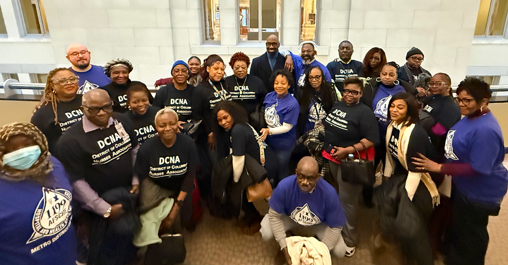 Large group of nurses wearing DCNA shirt, outside building