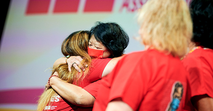 CNA/NNOC President Zenei Triunfo-Cortez hugging ncoming president Michelle Gutierrez Vo