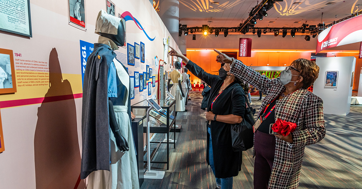 Nurses looking at timeline exhibit