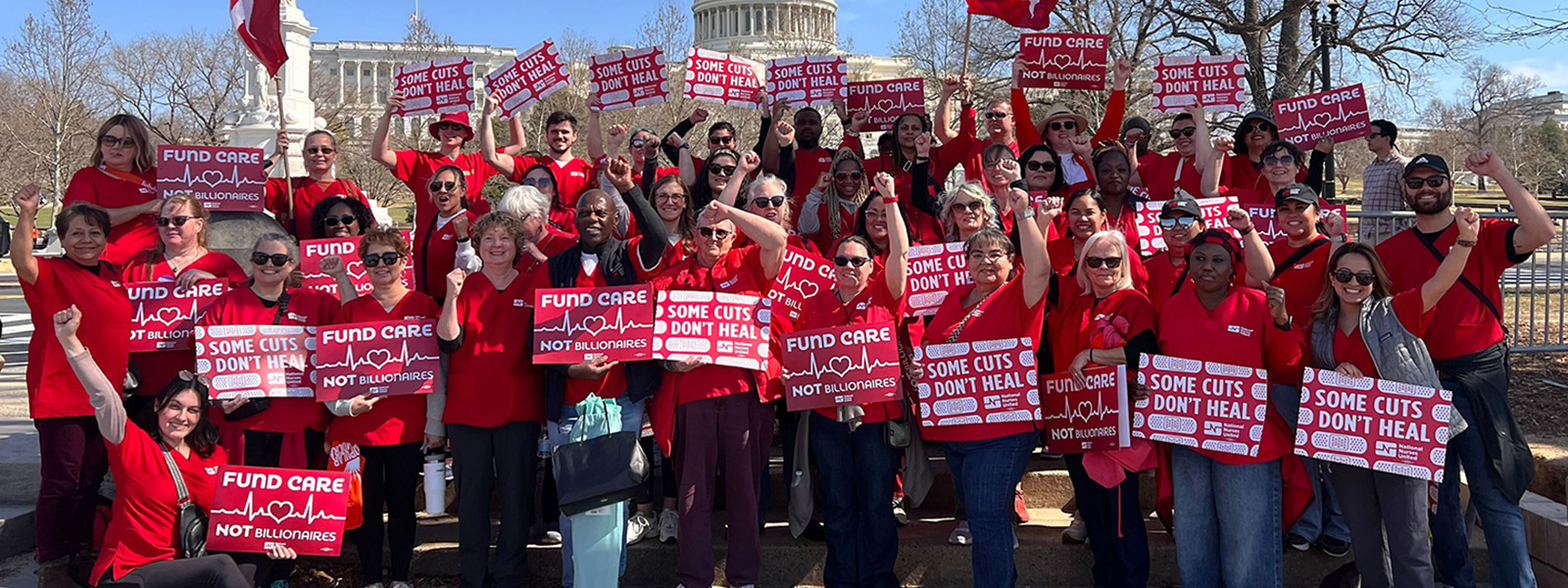 Nurses outside D.C. Capitol hlding signs "Fund Care Not Billionaires" and "Some Cuts Don't Heal"